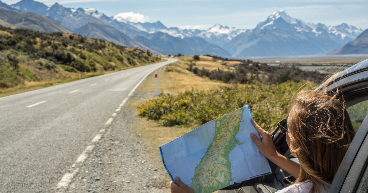 Person on a road trip using a map